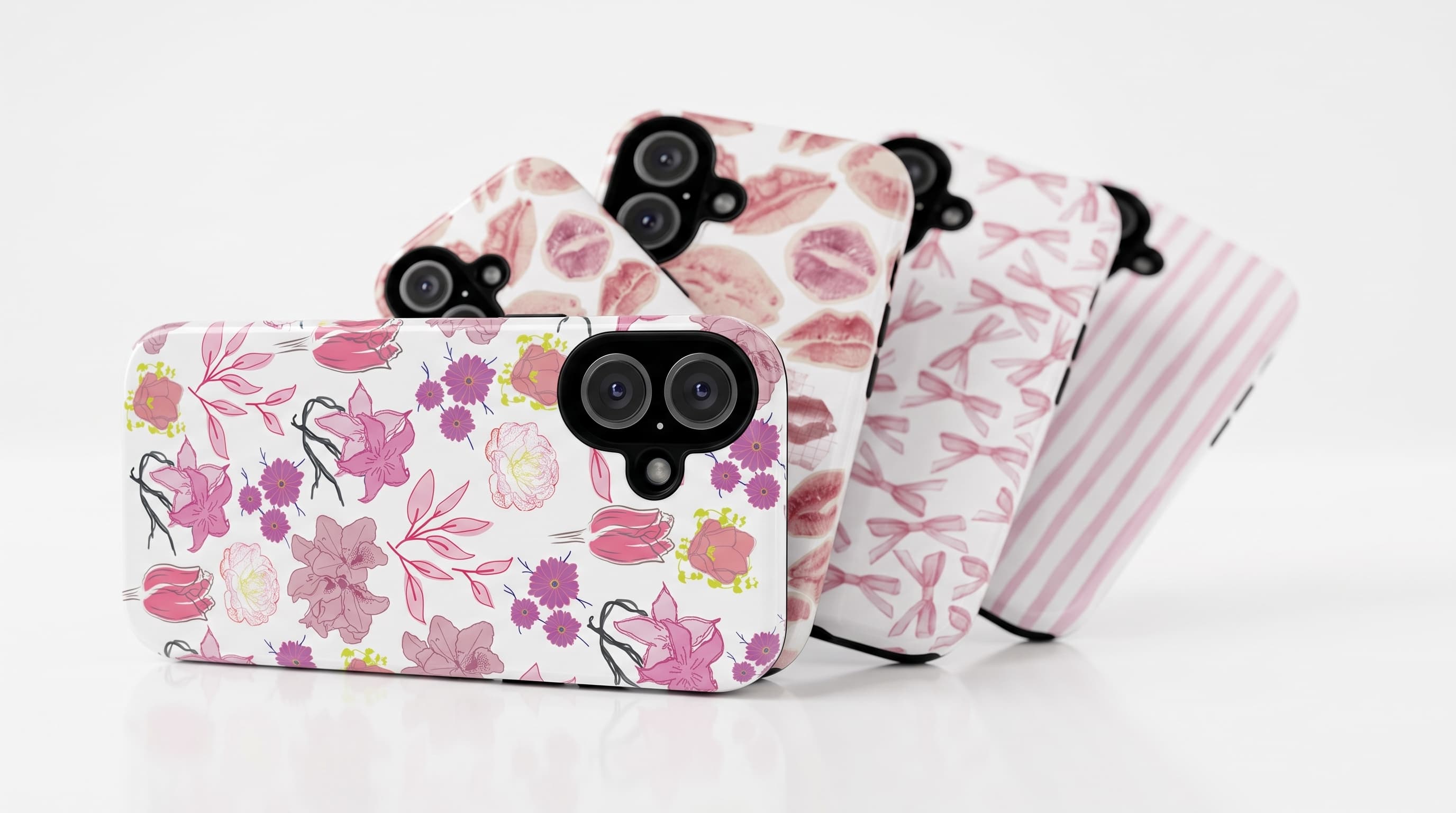 Two printed Avellé cases held against a cream blouse and blush ribbon
